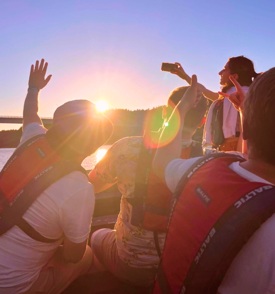Identio team on the water at sunset